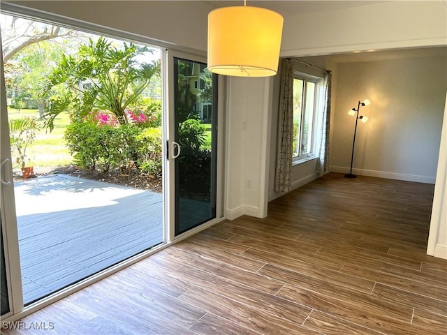 428 Meadowlark Ln Unit A, Naples, FL 34105 - doorway featuring baseboards and wood finished floors