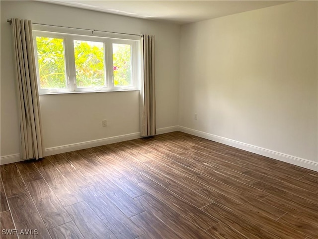 428 Meadowlark Ln Unit A, Naples, FL 34105 - unfurnished room with baseboards and dark wood-style floors