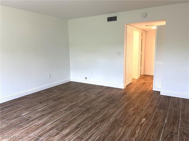 428 Meadowlark Ln Unit A, Naples, FL 34105 - spare room with baseboards, dark wood finished floors, and visible vents