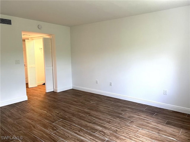 428 Meadowlark Ln Unit A, Naples, FL 34105 - empty room with baseboards, dark wood-style flooring, and visible vents