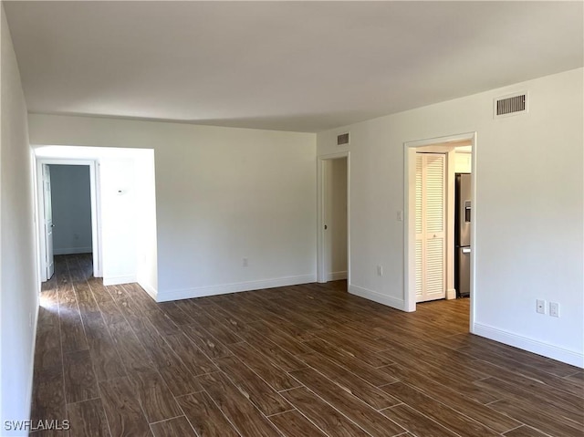 428 Meadowlark Ln Unit A, Naples, FL 34105 - empty room featuring baseboards, dark wood finished floors, and visible vents