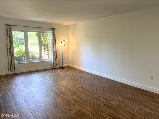 428 Meadowlark Ln Unit A, Naples, FL 34105 - spare room with baseboards and dark wood-style floors