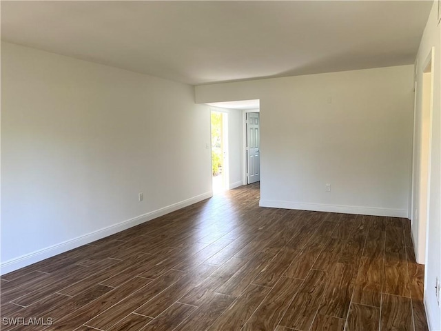 428 Meadowlark Ln Unit A, Naples, FL 34105 - empty room with baseboards and dark wood-style floors