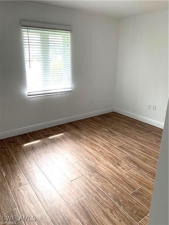 428 Meadowlark Ln Unit A, Naples, FL 34105 - unfurnished room featuring baseboards and wood finished floors