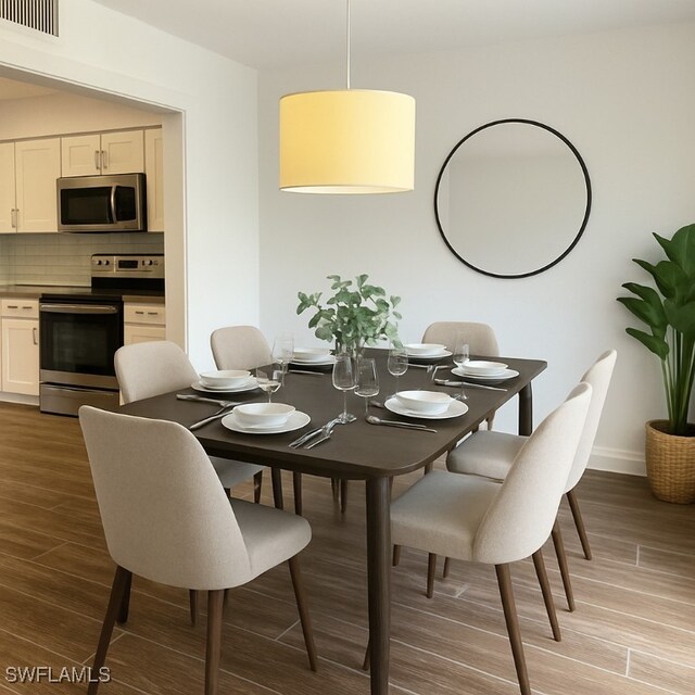 428 Meadowlark Ln Unit A, Naples, FL 34105 - dining area featuring visible vents, light wood finished floors, and baseboards
