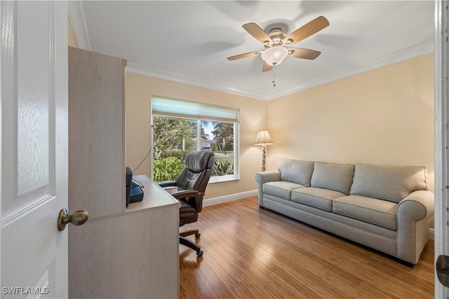 office area featuring wood finished floors, a ceiling fan, crown molding, and baseboards