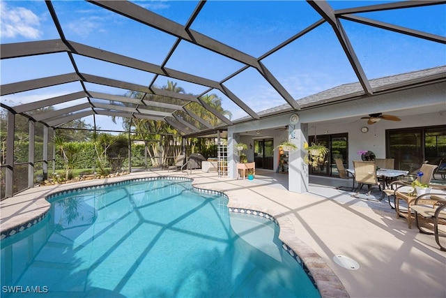pool with a ceiling fan and a patio area