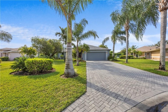 view of front of house with a garage, a front lawn, decorative driveway, and a residential view