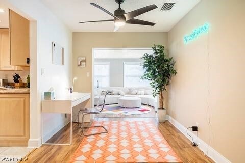 interior space featuring ceiling fan, visible vents, and light wood-style floors