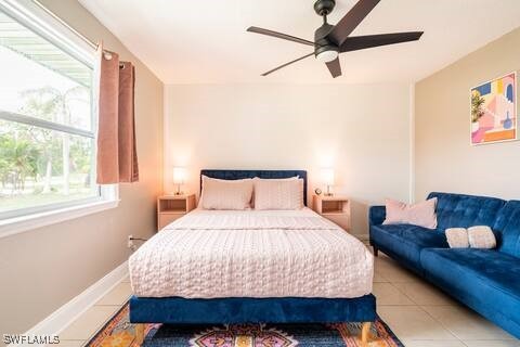 bedroom with a ceiling fan and tile patterned flooring