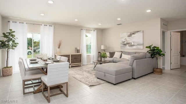 living area with recessed lighting, light tile patterned floors, and a wealth of natural light