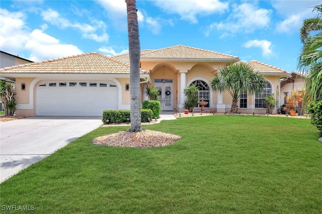 mediterranean / spanish-style house with a garage, a front lawn, concrete driveway, stucco siding, and a tile roof