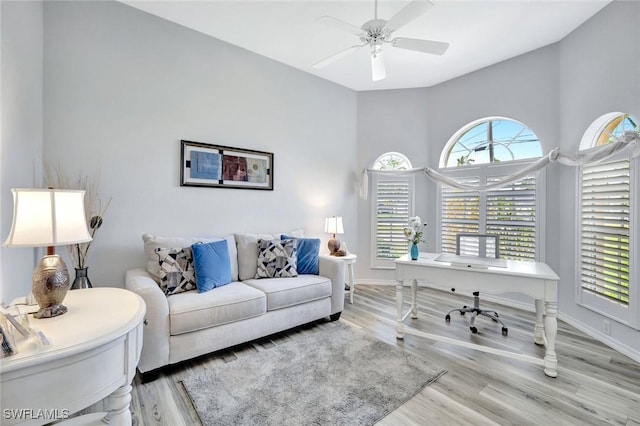 office area with wood finished floors, ceiling fan, and baseboards