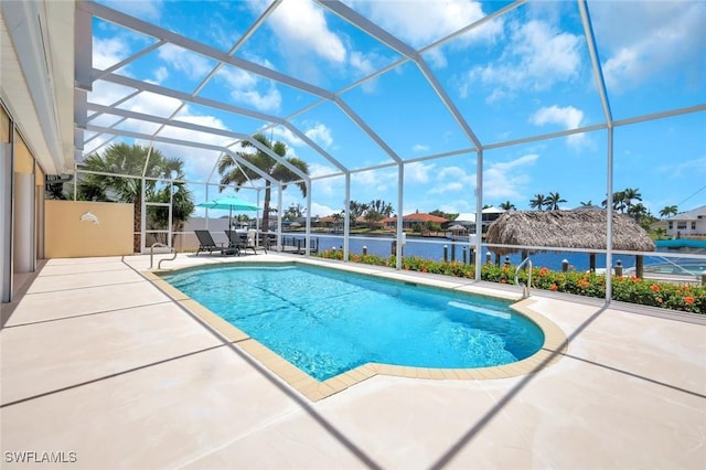 outdoor pool featuring a patio area and glass enclosure