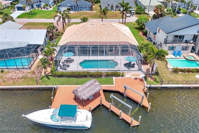 dock featuring a residential view, a water view, a patio, glass enclosure, and a pool with connected hot tub
