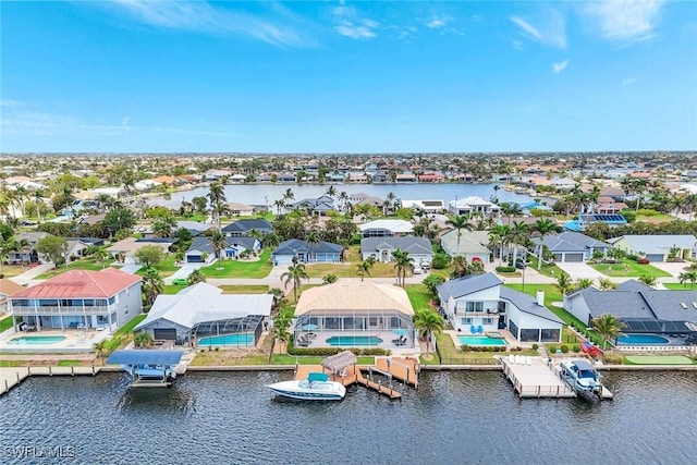 aerial view of residential area with a nearby body of water and a pool