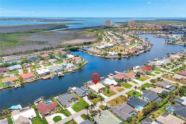 aerial overview of property's location featuring a large body of water and nearby suburban area