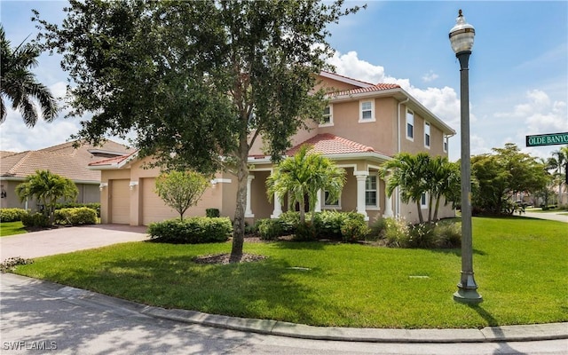 mediterranean / spanish-style house with a tiled roof, stucco siding, a front lawn, concrete driveway, and a garage
