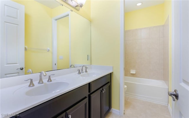 bathroom with toilet, tile patterned floors, and double vanity