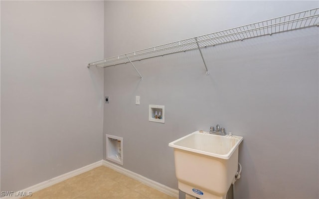 washroom with hookup for an electric dryer, washer hookup, baseboards, and light tile patterned floors
