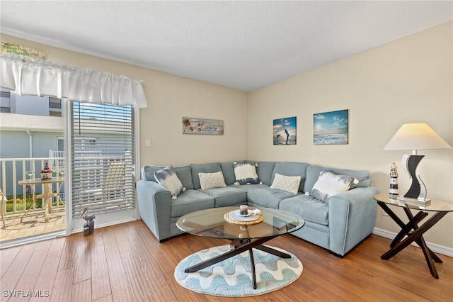 3330 N Key Dr Unit 6, North Fort Myers, FL 33903 - living room featuring baseboards and wood finished floors
