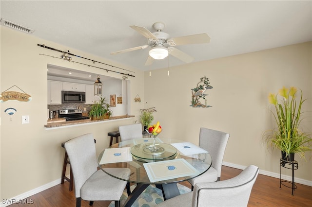 3330 N Key Dr Unit 6, North Fort Myers, FL 33903 - dining area featuring baseboards, a ceiling fan, dark wood finished floors, and visible vents