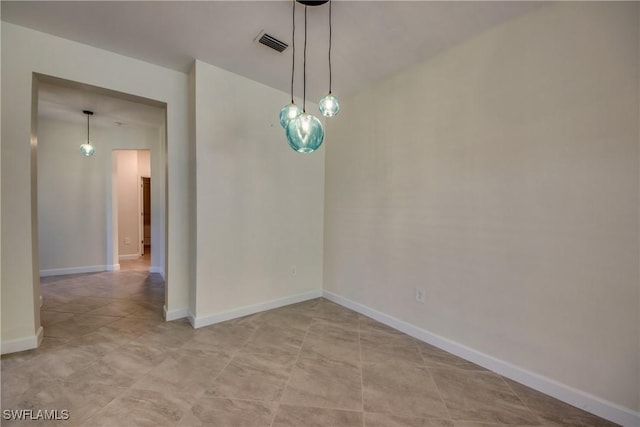 spare room with baseboards and visible vents