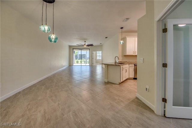 interior space featuring a sink, baseboards, ceiling fan, and light tile patterned flooring