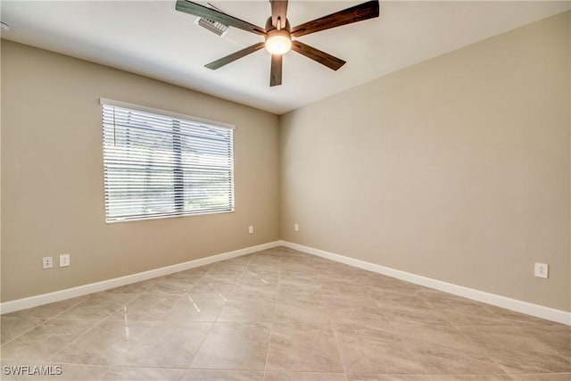 unfurnished room featuring ceiling fan, visible vents, and baseboards