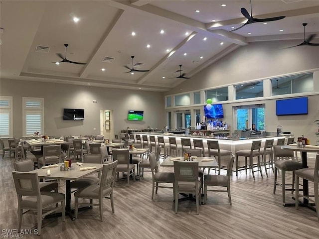 dining room with ceiling fan, visible vents, and wood finished floors