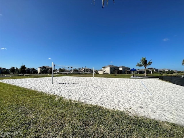 view of property's community featuring volleyball court and a yard