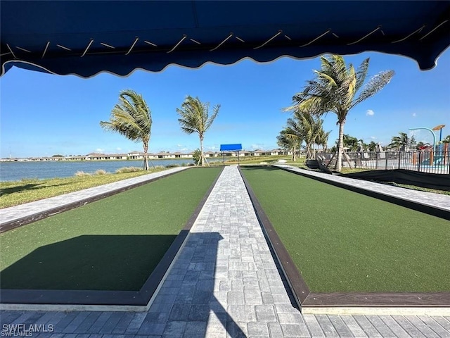 surrounding community featuring a water view and fence
