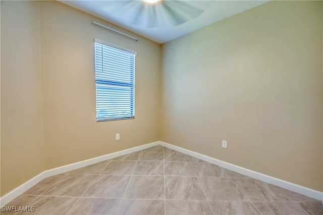 spare room with baseboards