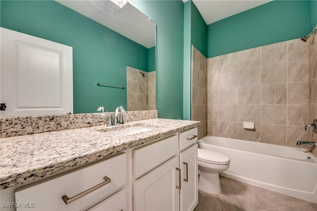 bathroom with vanity, tile patterned floors, toilet, and shower / washtub combination