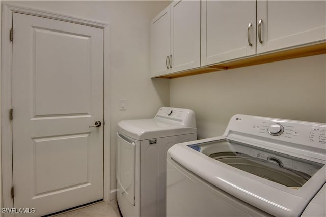 laundry area featuring washer and dryer and cabinet space