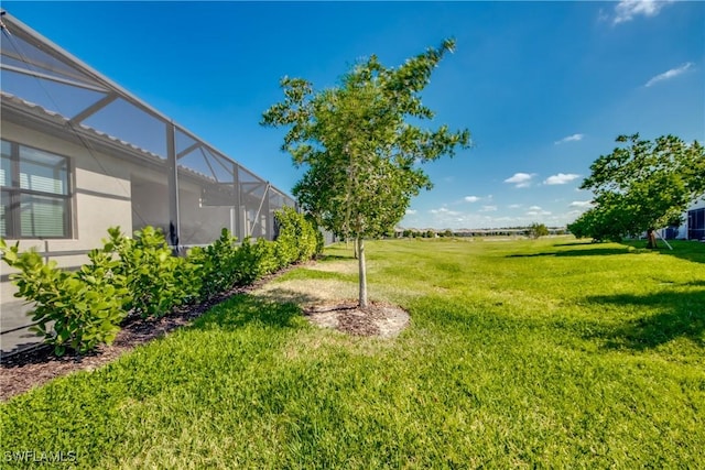 view of yard featuring glass enclosure