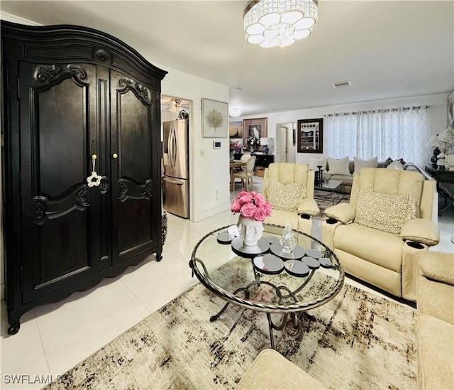 living room with light tile patterned floors, a chandelier, and visible vents