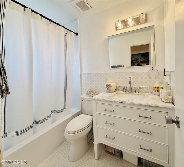 bathroom with visible vents, tile patterned flooring, vanity, toilet, and shower / bathtub combination with curtain