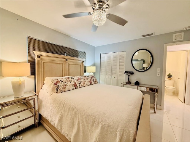 bedroom with a ceiling fan, visible vents, light tile patterned floors, and a closet