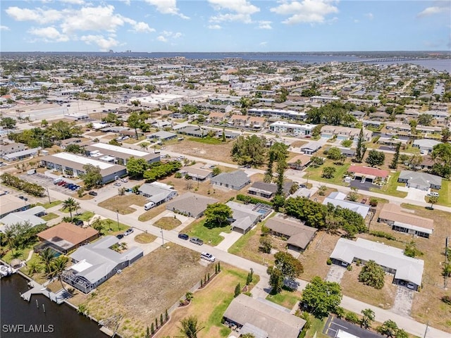 birds eye view of property featuring a water view and a residential view