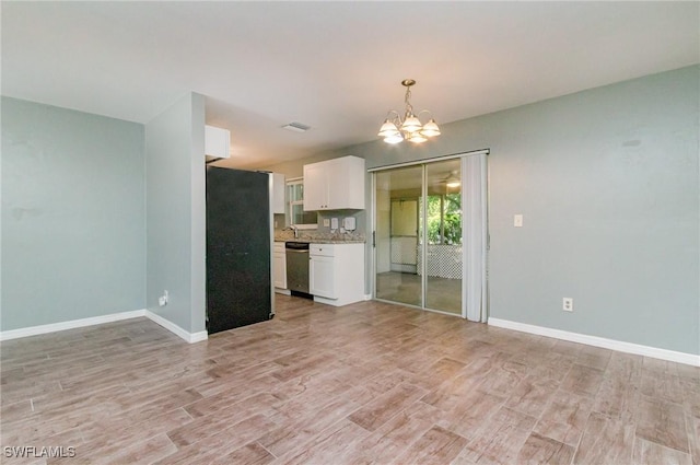 interior space featuring light wood finished floors, visible vents, baseboards, and a notable chandelier