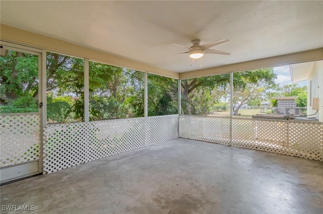 unfurnished sunroom with a ceiling fan