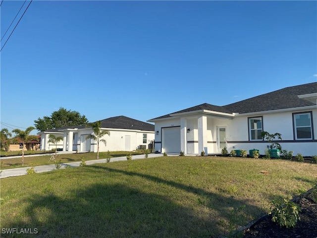 5249-5251 Centennial Blvd, Lehigh Acres, FL 33971 - view of front facade featuring stucco siding, an attached garage, a front yard, and concrete driveway