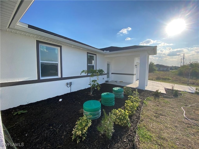 5249-5251 Centennial Blvd, Lehigh Acres, FL 33971 - view of property exterior with a patio and stucco siding