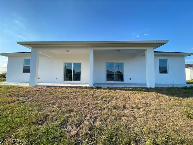 5249-5251 Centennial Blvd, Lehigh Acres, FL 33971 - back of property featuring stucco siding and a yard