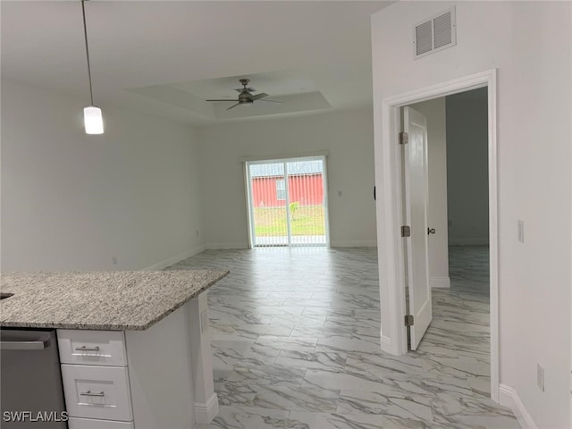5249-5251 Centennial Blvd, Lehigh Acres, FL 33971 - kitchen with light marble finish flooring, baseboards, ceiling fan, a raised ceiling, and white cabinetry