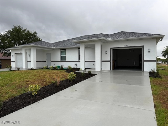 5249-5251 Centennial Blvd, Lehigh Acres, FL 33971 - prairie-style house featuring driveway, an attached garage, stucco siding, and a front lawn