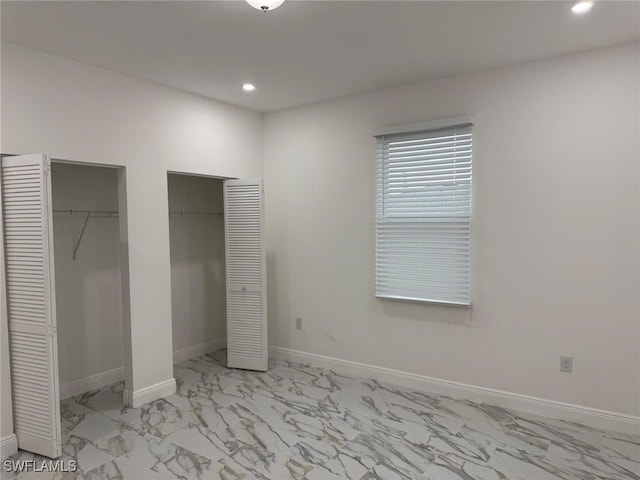 5249-5251 Centennial Blvd, Lehigh Acres, FL 33971 - unfurnished bedroom featuring multiple closets, light marble finish flooring, recessed lighting, and baseboards