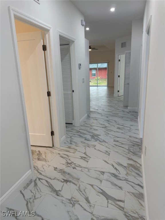 5249-5251 Centennial Blvd, Lehigh Acres, FL 33971 - hall featuring recessed lighting, light marble finish flooring, and baseboards