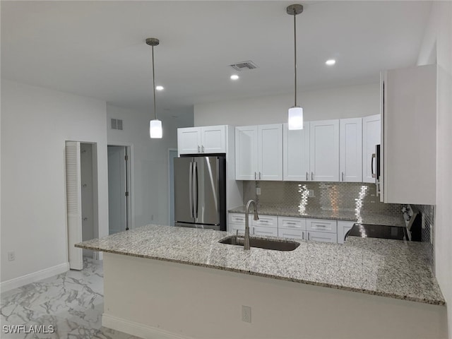 5249-5251 Centennial Blvd, Lehigh Acres, FL 33971 - kitchen with stainless steel appliances, a sink, a peninsula, light stone counters, and light marble finish floors